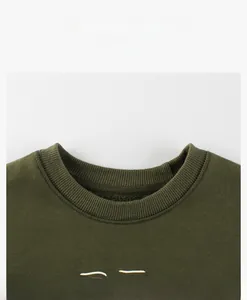Detail view of the ribbed round neckline on this dark olive green fleece sweatshirt