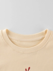 Close-up of cream crewneck long-sleeve cotton T-shirt with reinforced ribbed collar