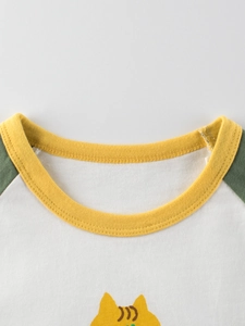 Girls long sleeve cotton T-shirt featuring green raglan sleeves and yellow crew neck