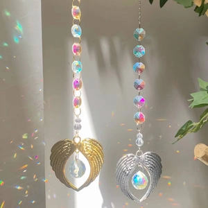 Detail of K9 crystal suncatcher showing golden and silver heart wing rainbow makers