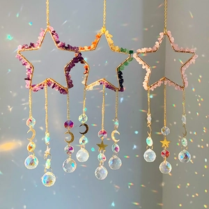 Detailed view of handmade star suncatchers with natural crystal stones and hanging prisms