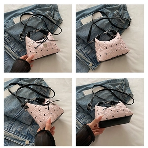 Pink quilted shoulder bag with black bows and heart charm shown in multiple angles
