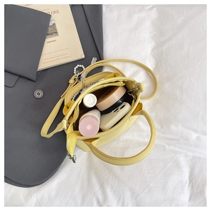 Internal view of yellow bucket bag showing spacious storage and inner zipper pocket