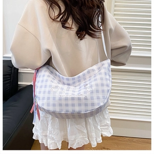 Detailed back view of a lavender plaid hobo bag with heart embroidery and ribbon