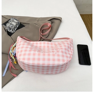 Detailed top view of pink checkered crescent bag with embroidery and adjustable strap
