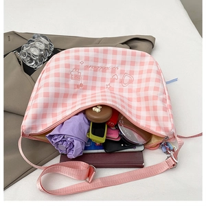Detailed internal view of pink checkered crossbody bag showing spacious storage capacity