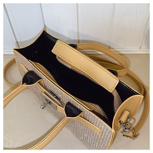 Detail of crossbody bag showing interior lining, zipper pocket, and metallic textures