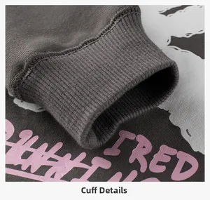 Detail of ribbed cuff on dark gray hoodie with pink FRED graffiti style print