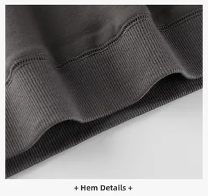 Detailed macro view of the dark grey ribbed hem on this fleece-lined kids sweatshirt