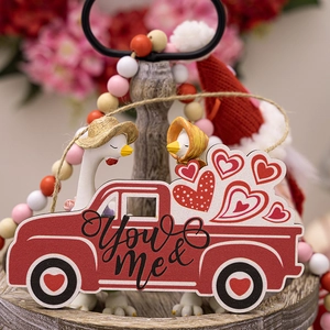 Romantic Valentine's Day wood truck decor with hearts and cute goose figures on a tray