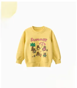 Detail of yellow kids sweatshirt featuring summer bear print and cozy cotton texture