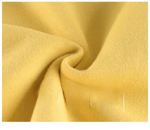 Close-up of soft yellow cotton knit fabric showing breathable texture and skin-friendly weave