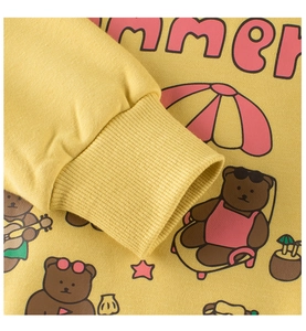 Close-up of ribbed cuffs and summer bear prints on this yellow cotton girl's sweatshirt