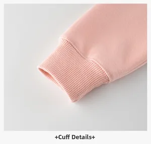 Macro view of pink ribbed cuffs on a soft fleece hoodie for girls with neat stitching