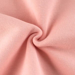 Close-up of pink polar fleece fabric texture showing soft knit fibers for girl's sweater