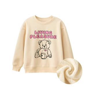 Detail of beige fleece-lined sweatshirt showing bear print and interior fabric texture
