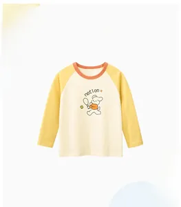 Detail of kids long sleeve cotton tee featuring cartoon dog print and raglan sleeves