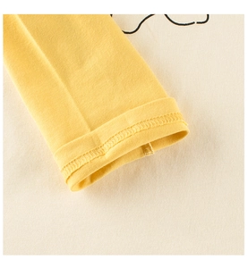 Detail view of cotton long sleeve cuffs showing premium flatlock stitching on kids t-shirt
