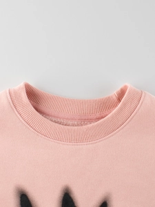 Pink fleece sweatshirt for girls with black graffiti print and warm interior lining