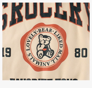 Detail of vintage bear graphic print on beige cotton sweatshirt for kids