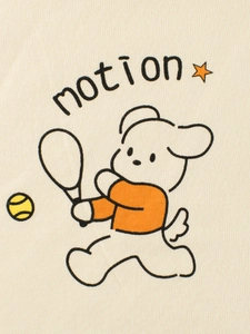 Close-up of beige cotton kids T-shirt with motion dog tennis print and star detail