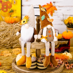 Detail of harvest gnome dolls with maple leaf and sunflower on rustic wooden display