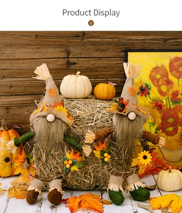 Close-up of autumn harvest gnomes with sunflowers and maple leaves on burlap fabric
