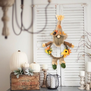 Detailed view of burlap gnome wreath with autumn maple leaves and sunflowers