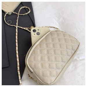 Quilted crossbody bag with chain strap showing internal capacity for a smartphone