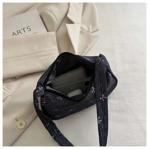 Internal view of navy denim shoulder bag showing storage capacity for phone and wallet