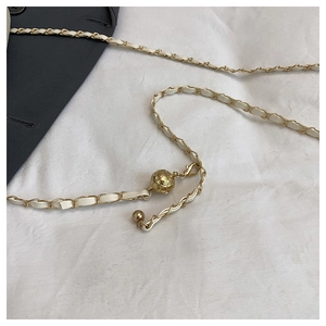 Detail of white leather and gold metal chain strap with adjustable gold sphere bead