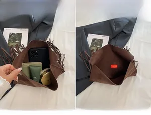Detail view of brown suede crossbody bag interior showcasing spacious main compartment