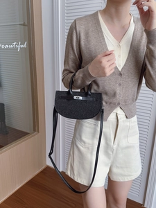 Sparkly black crescent handbag with silver metal buckle and elegant leather shoulder strap