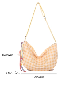 Chic yellow checkered crossbody sling bag with adjustable strap and decorative tassels