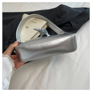Detailed view of silver metallic PU leather shoulder bag with decorative knotted zip puller