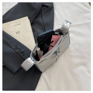 Detailed top view of silver mirrored handbag interior showing phone and cosmetics space