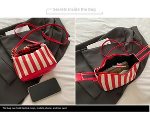 Internal view of striped canvas crossbody bag showing main compartment capacity