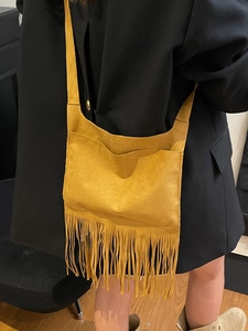 Retro mustard yellow faux suede crossbody bag with long tassels and fringe detail