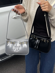 Fashionable mini faux leather shoulder bags in silver and black with drawstring details