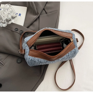 Internal view of blue plush crossbody bag showing space for phone and wallet with PU leather strap