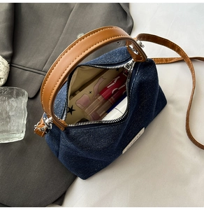 Detail view of denim handbag interior showcasing spacious storage for cosmetics and essentials