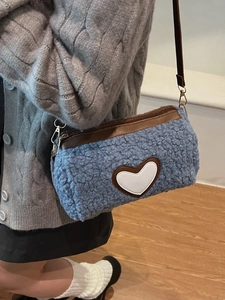 Blue faux shearling cylinder bag with white heart patch and brown leather straps