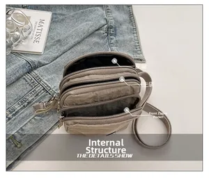 Detail of light coffee pleated nylon crossbody bag showing multiple pockets and zippers