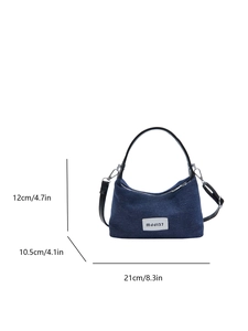 Dark blue denim shoulder bag with white MJJI37 patch and black adjustable strap