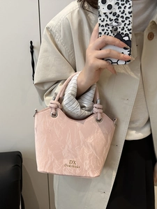 Chic pink pleated tote bag with silver eyelets and dual handles for autumn fashion