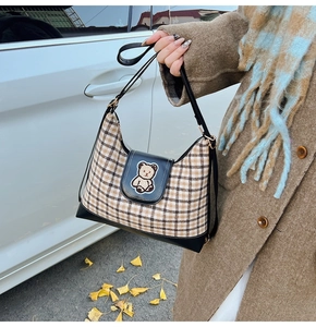 Detailed view of large plaid tote bag with cute bear embroidery and leather shoulder strap
