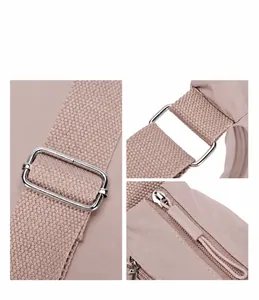 Close-up of pink nylon bag details showing silver metal buckles and reinforced stitching
