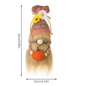 Detail of 23cm knitted harvest gnome with orange pumpkin and daisy accent on cap