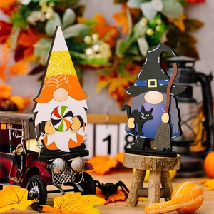 Close-up of wooden Halloween gnomes with wizard hat and pumpkin candy props