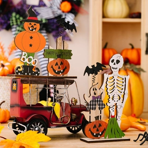 Detail of Halloween wooden ghost signs with BOO text and red vintage truck decor